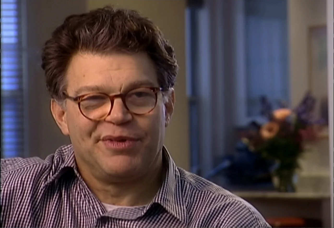 Indian Point: Imagining the Unimaginable (2004) movie still: closeup — A well-lit indoor space featuring a man sitting near a window with a vase. He…