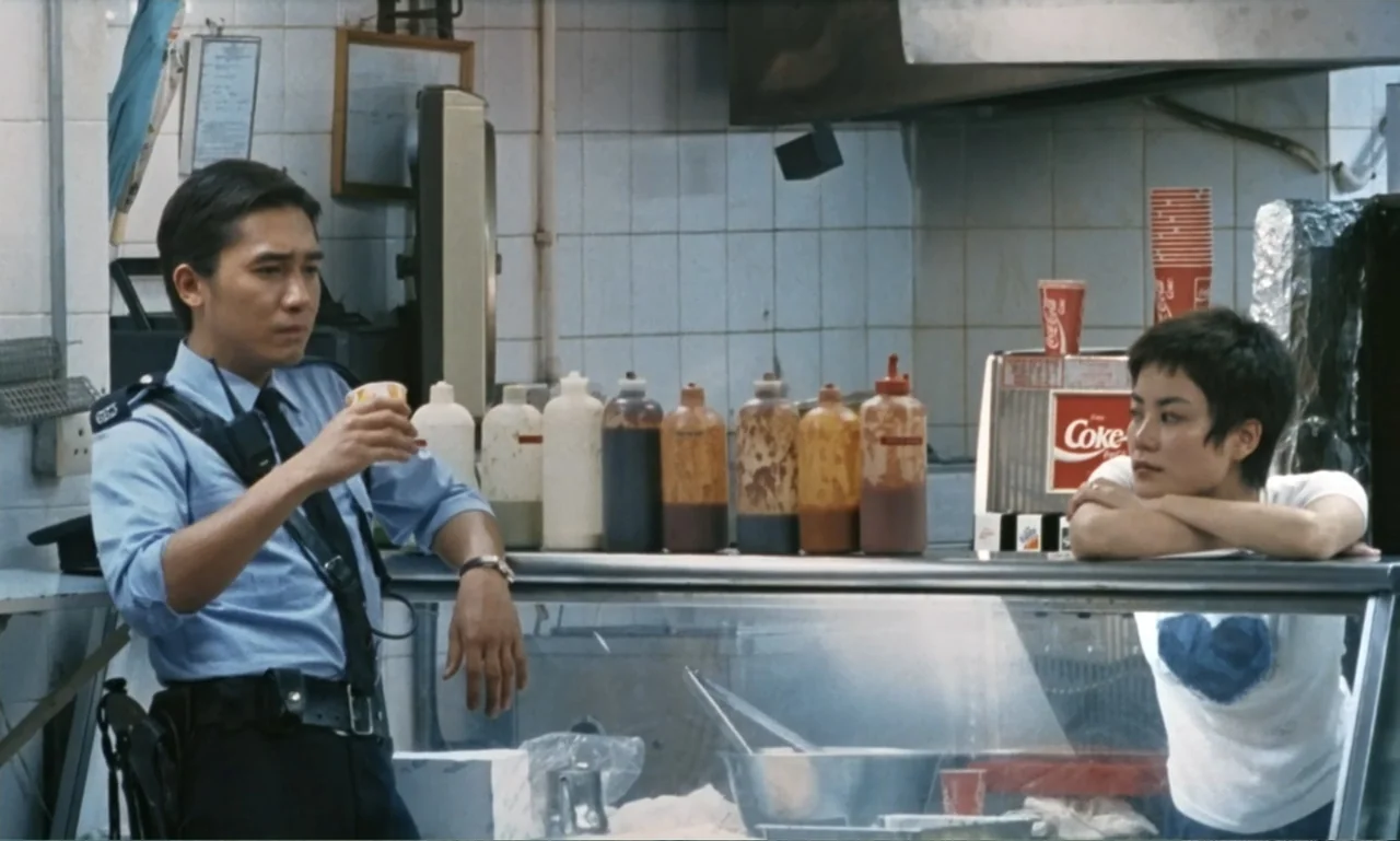 Chungking Express (1994) movie still: medium — A tiled snack bar service area displays rows of condiment bottles and paper cups. A man in a uniform…