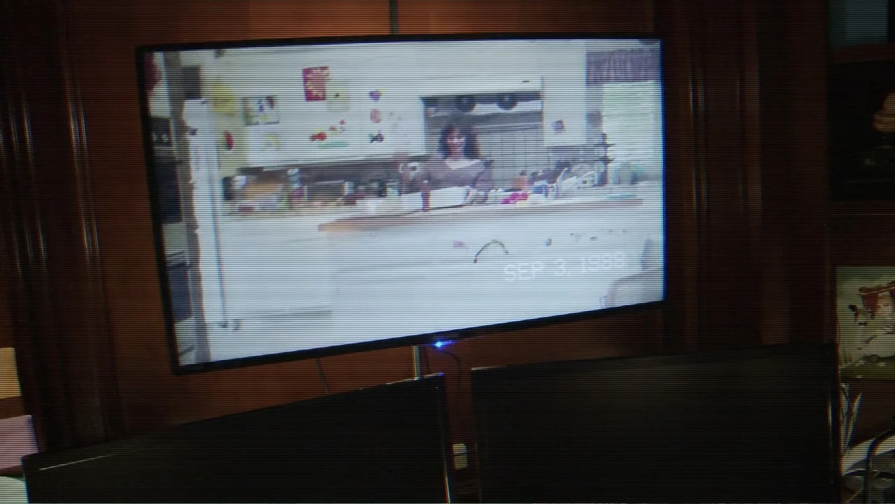 Paranormal Activity: The Ghost Dimension (2015) movie still: medium — A dated 1980s residential kitchen features white cabinetry and a cluttered…