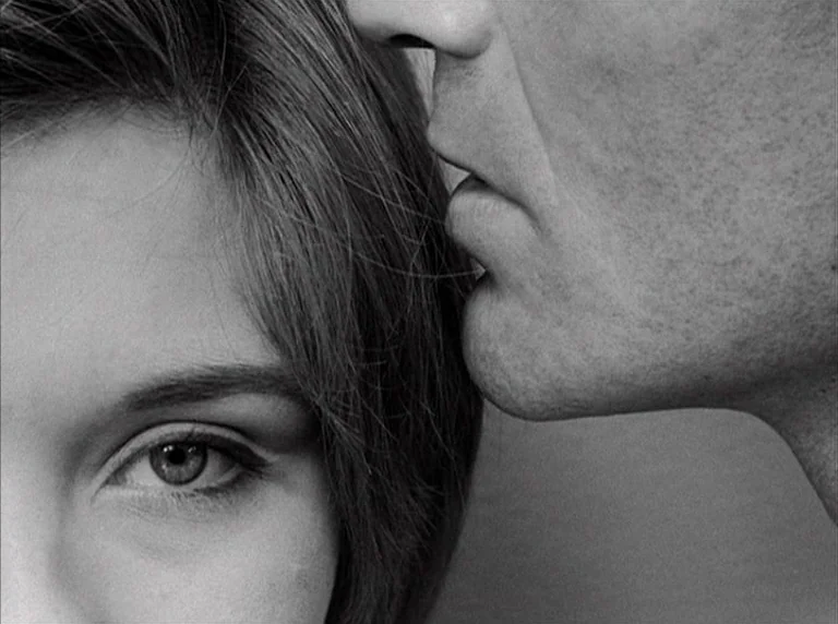 Une Femme Mariée (1964) movie still: closeup — A close up frame features the side of a man's face near a woman's eye. The composition emphasizes…