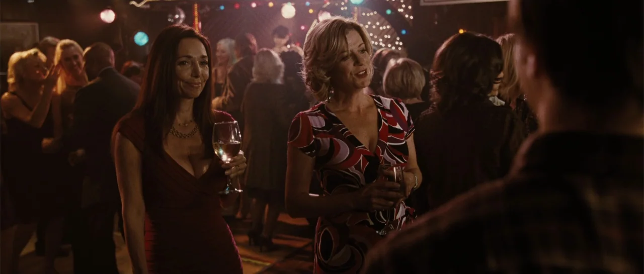 Going the Distance (2010) movie still: medium — A crowded nightclub interior features festive lighting strings and patrons standing in the…