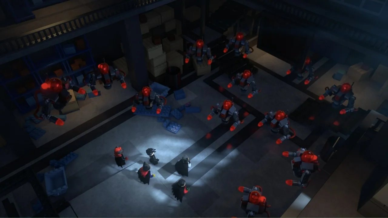 LEGO DC Batman: Family Matters (2019) movie still: wide — A dark industrial warehouse filled with cardboard boxes and stacked storage units. Four…