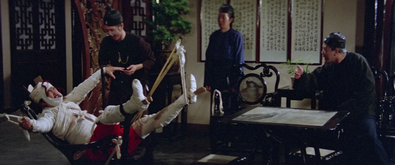 Encounter of the Spooky Kind (1980) movie still: wide — A room features traditional Chinese wooden furniture, calligraphy wall scrolls, and a small…