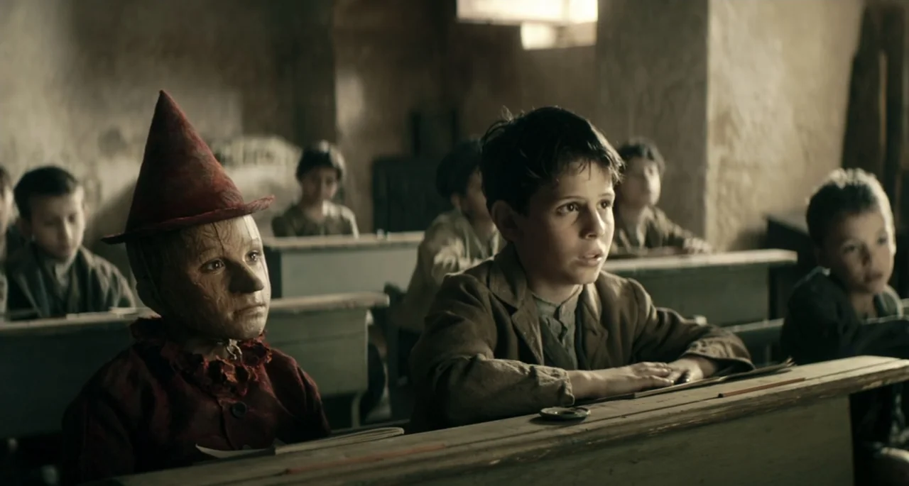 Pinocchio (2022) movie still: medium — A dimly lit classroom features rows of aged wooden desks and peeling plaster walls. A young boy sits…