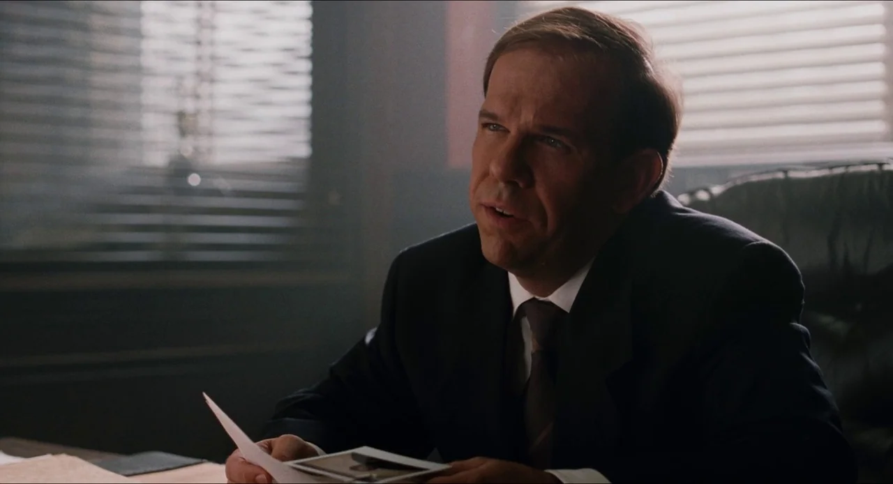 Deep Cover (1992) movie still: medium — An interior office space features horizontal window blinds filtering daylight into the room. A man in a…