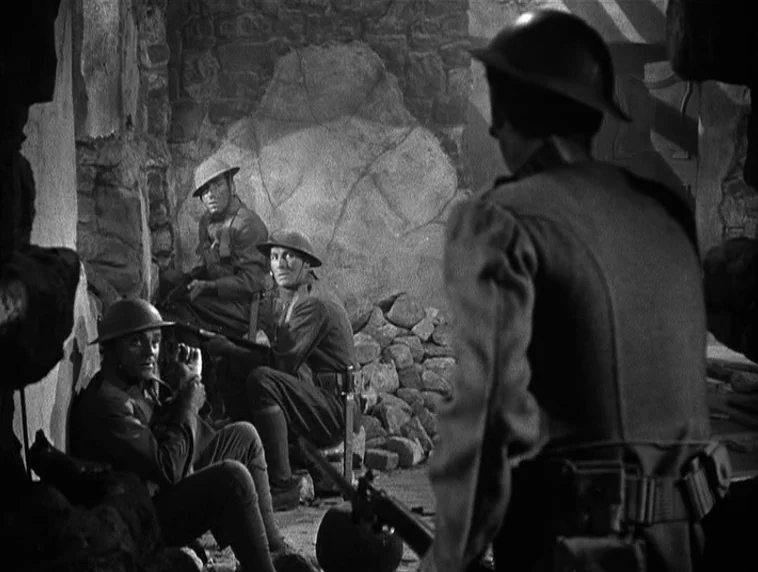 The Roaring Twenties (1939) movie still: medium — A stone bunker interior is filled with piles of rubble and rough masonry walls. Four soldiers in…