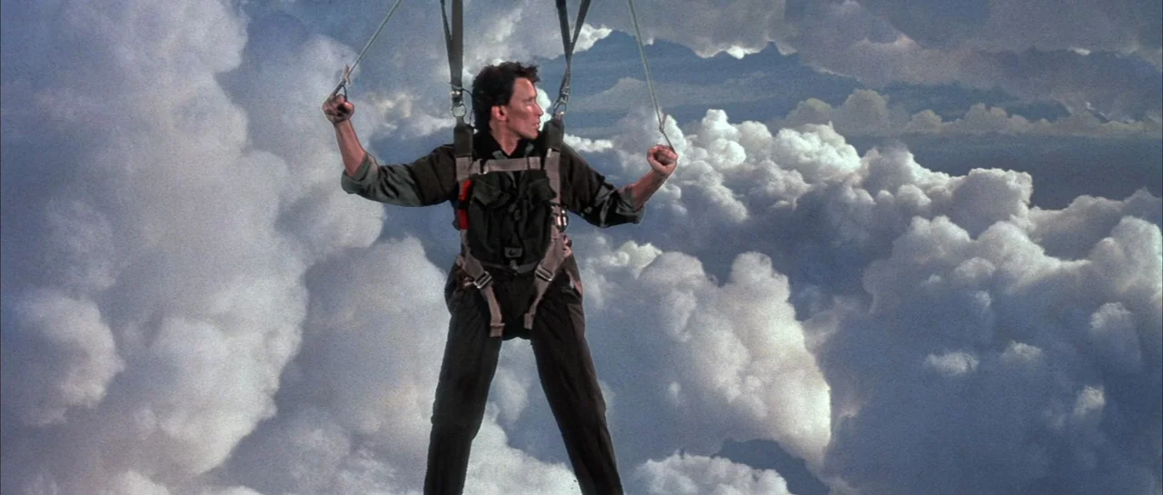 The Adventures of Buckaroo Banzai Across the 8th Dimension (1984) movie still: fullbody — A man floats through a dense field of white cumulus clouds…