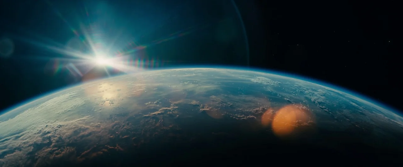 Leave The World Behind (2023) movie still: establishing — The curvature of the Earth is visible against the dark expanse of outer space. A bright…