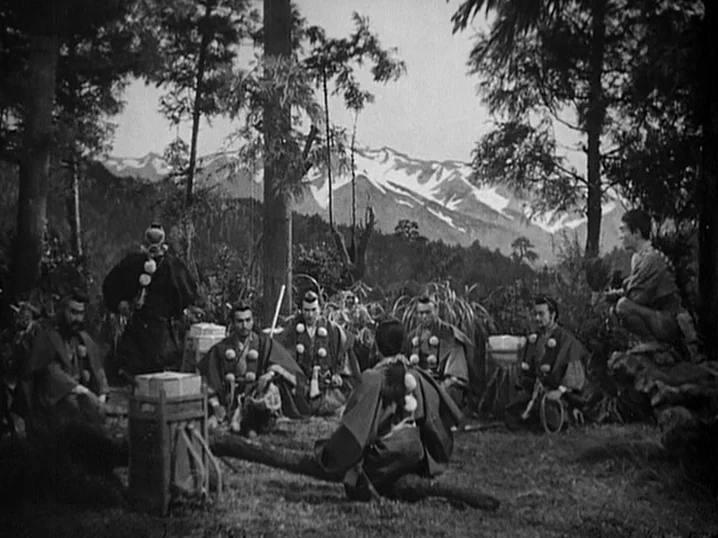 The Men Who Tread on the Tigers Tail (1945) movie still: wide — A group of men in traditional Japanese robes sits in a mountain forest clearing.…