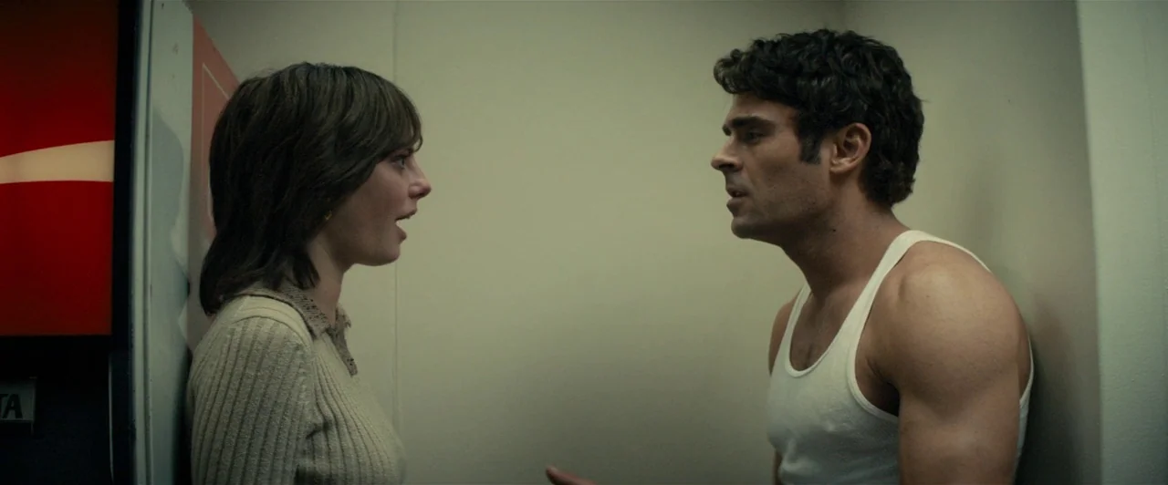 Extremely Wicked, Shockingly Evil and Vile (2019) movie still: medium — A cramped, dimly lit indoor space features a red vending machine against a…