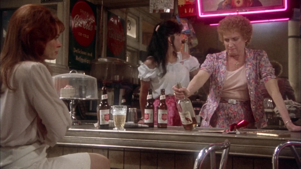 Come Back to the 5 & Dime Jimmy Dean, Jimmy Dean (1982) movie still: medium — A retro bar features Coca-Cola signage, glass bottles, and a prominent…