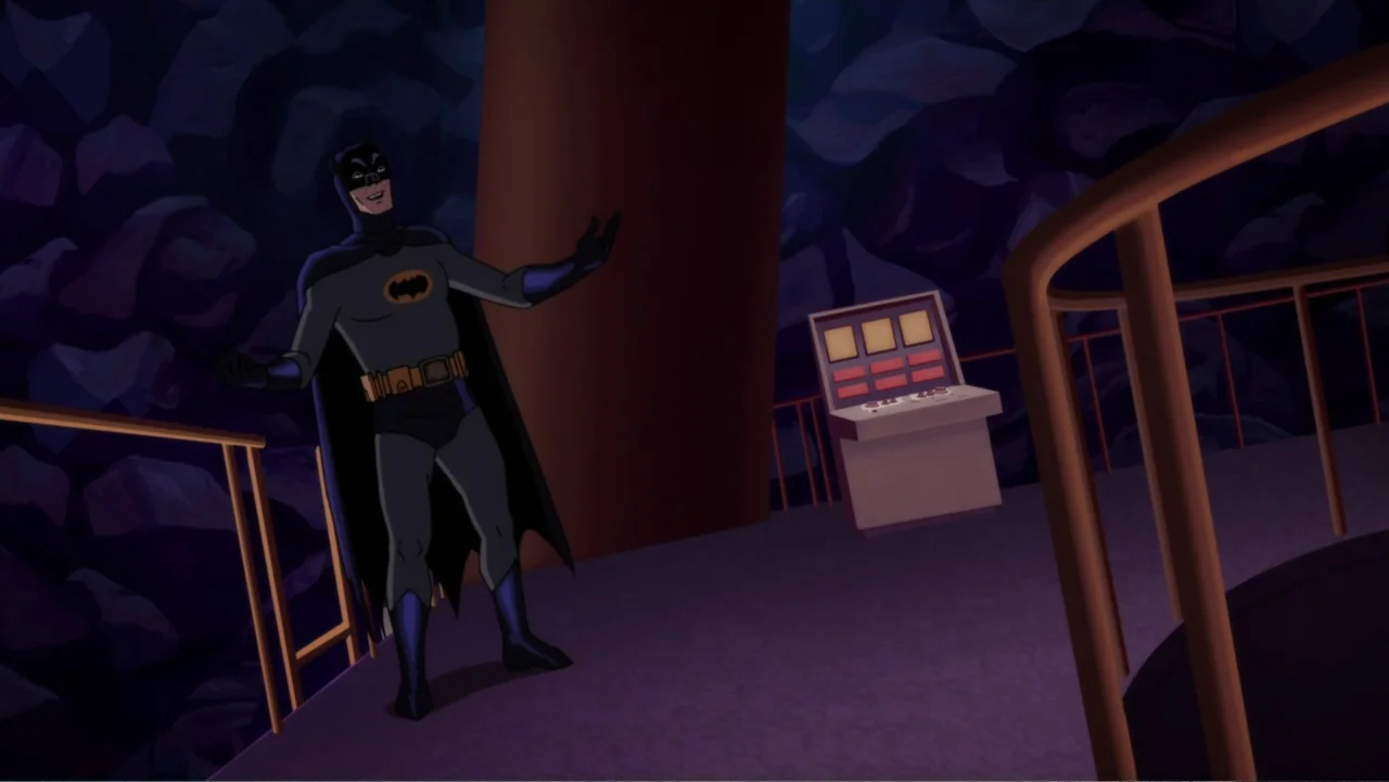 Batman: Return of the Caped Crusaders (2016) movie still: fullbody — A dark subterranean cavern setting features rocky walls and a metal railed…