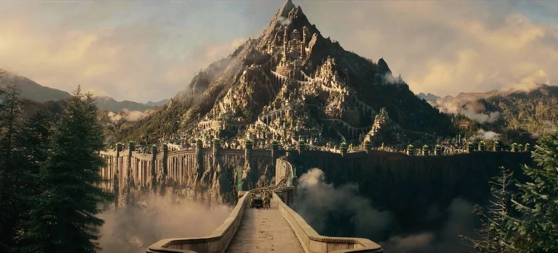 Avatar: The Last Airbender (2005) movie still: establishing — A vast ancient city is carved into the slopes of a massive rocky mountain. A long…