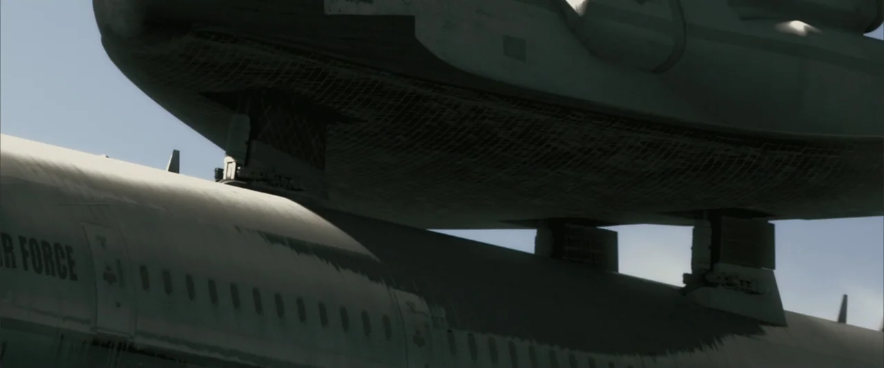 Superman Returns (2006) movie still: wide — A NASA space shuttle is docked to the top of a large aircraft. The metallic surfaces of both vessels are…