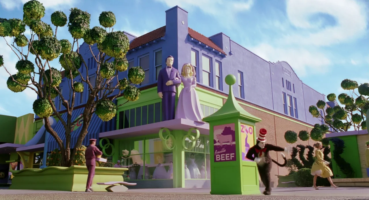 The Cat In The Hat (2003) movie still: wide — A whimsical town square features a purple building with statues of a bride and groom. The Cat in the…