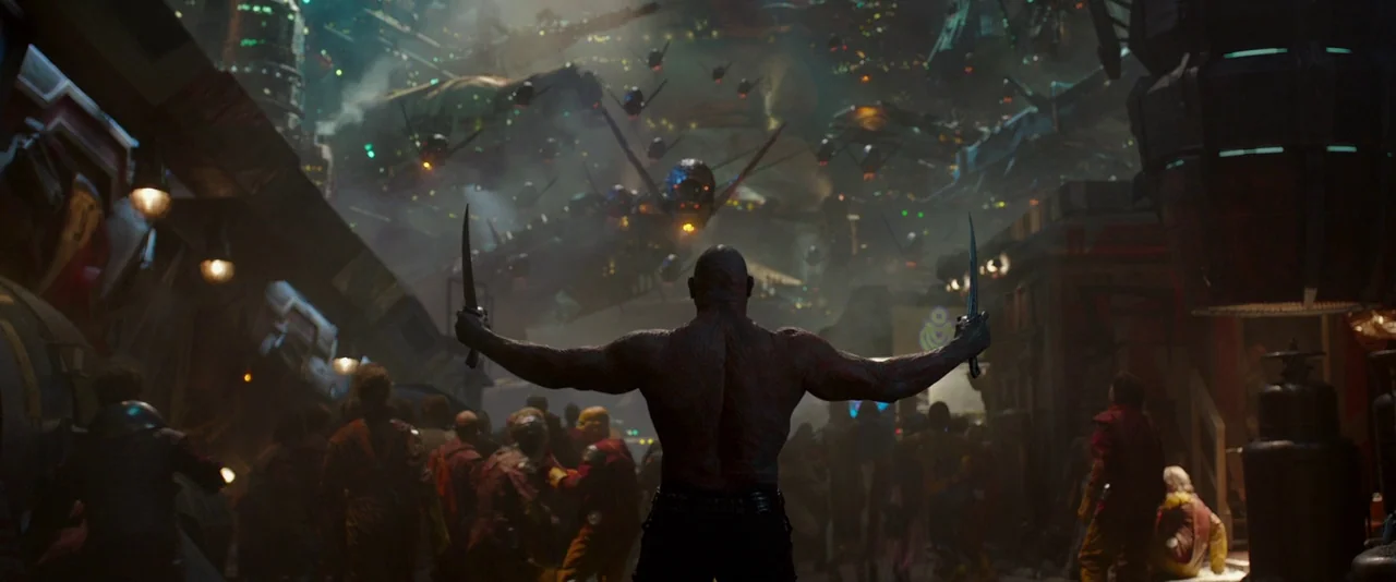 Guardians of the Galaxy (2014) movie still: fullbody — A crowded marketplace on a futuristic alien planet is filled with many flying warships above.…