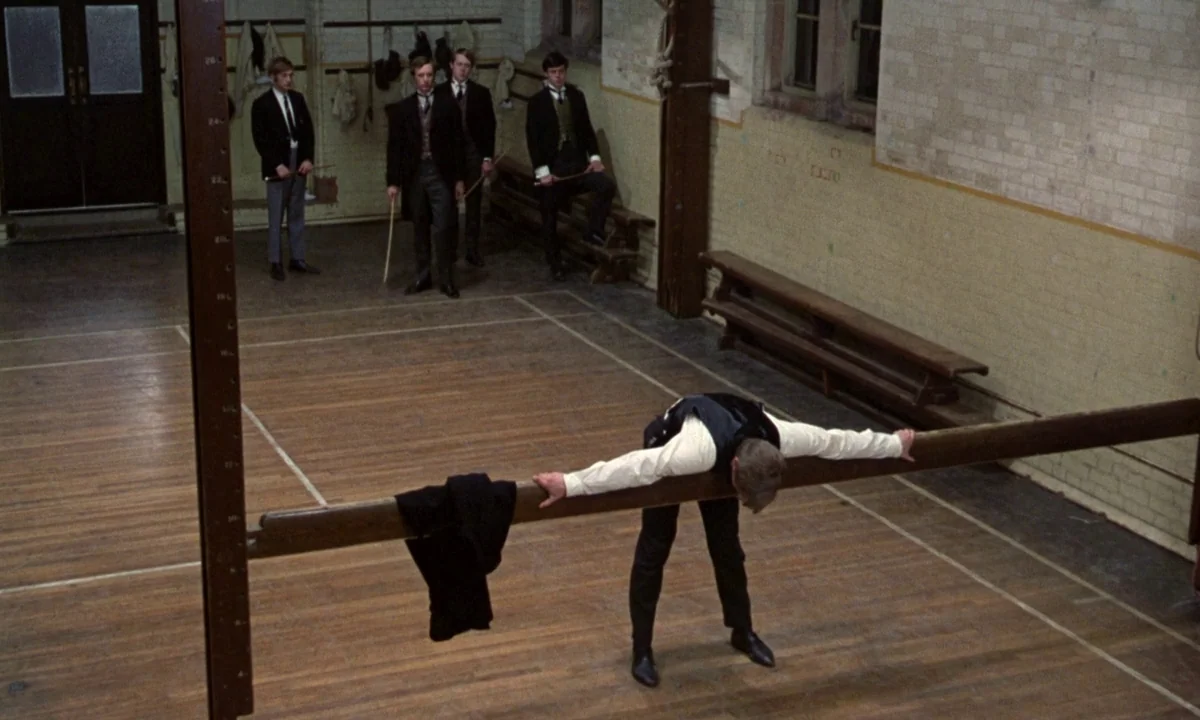 If…. (1968) movie still: wide — A high-ceilinged gymnasium features painted brick walls and a polished wooden floor. Five teenage boys in school…
