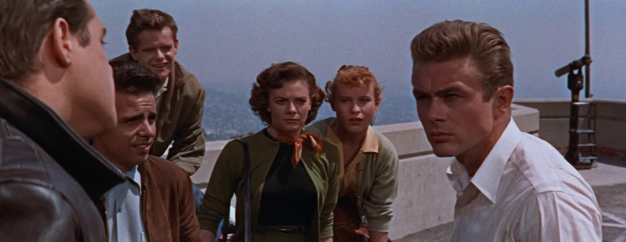 Rebel Without A Cause (1955) movie still: medium — A group of five young people stands on an outdoor concrete observation deck. They are gathered…