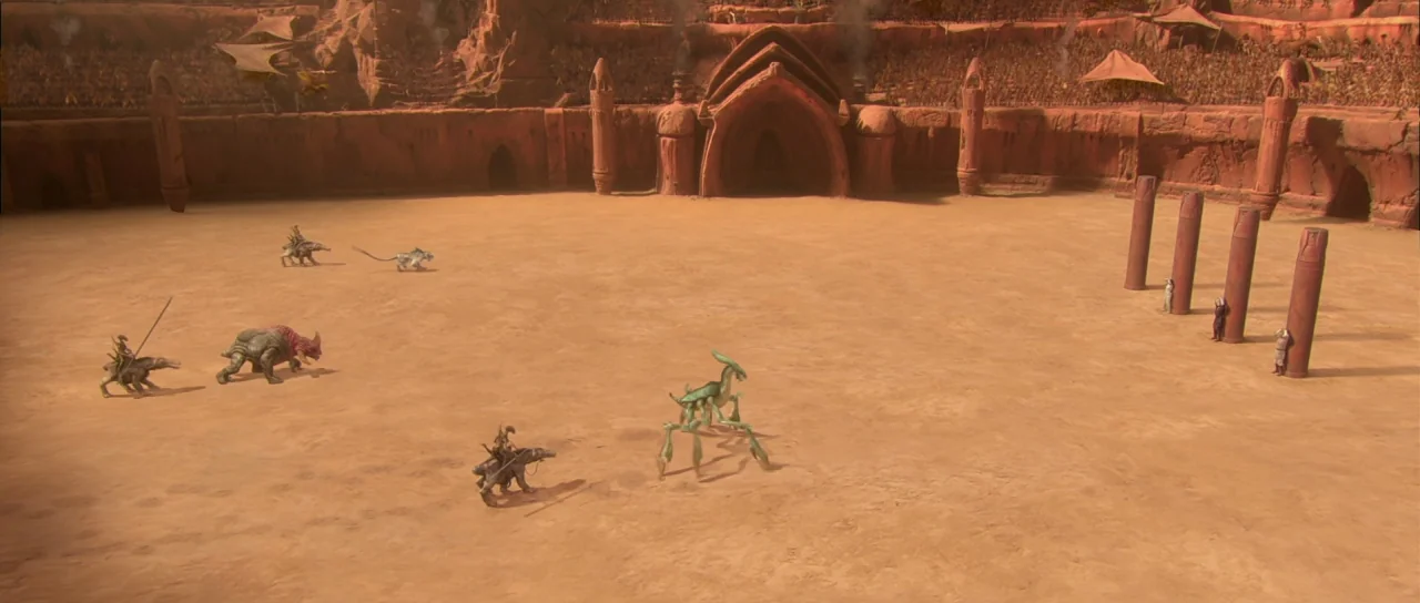 Star Wars: Episode II – Attack of the Clones (2002) movie still: wide — A vast circular sand arena is surrounded by towering red stone seating…