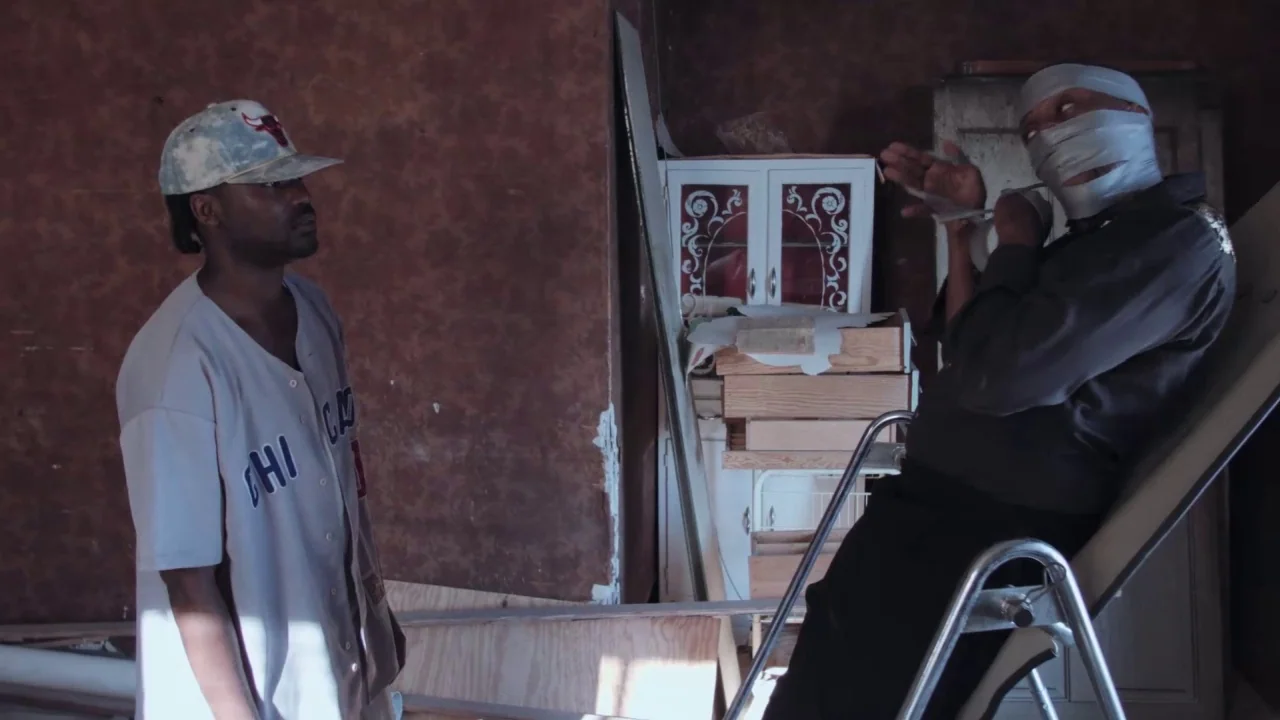 Collective: Unconscious (2016) movie still: medium — A cluttered room with brown walls and a white cabinet in the background. A man stands over…