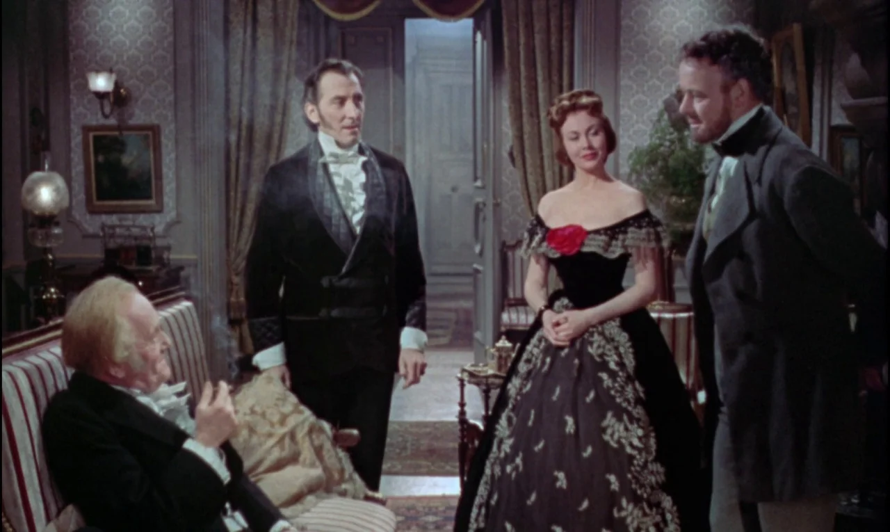 The Curse of Frankenstein (1957) movie still: medium — A lavish Victorian parlor features patterned wallpaper, heavy curtains, and dark wood…