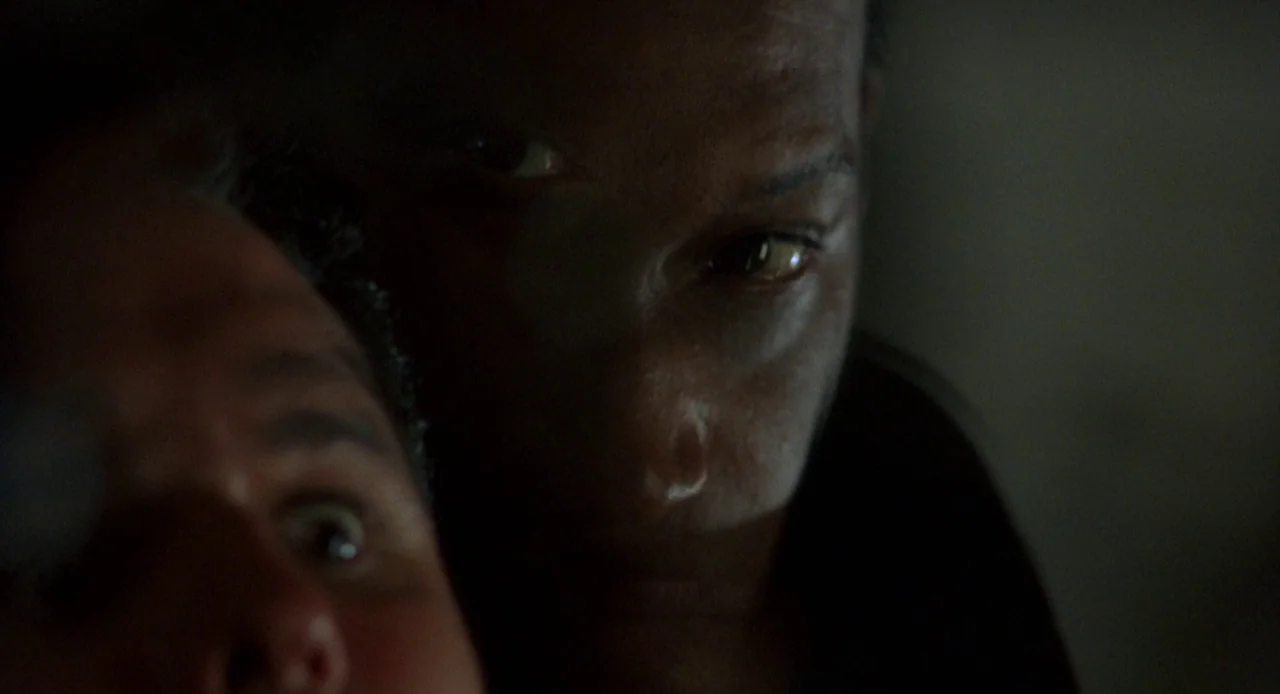 Candyman: Farewell to the Flesh (1995) movie still: closeup — Two individuals are positioned close together in an extremely dark, dimly lit…