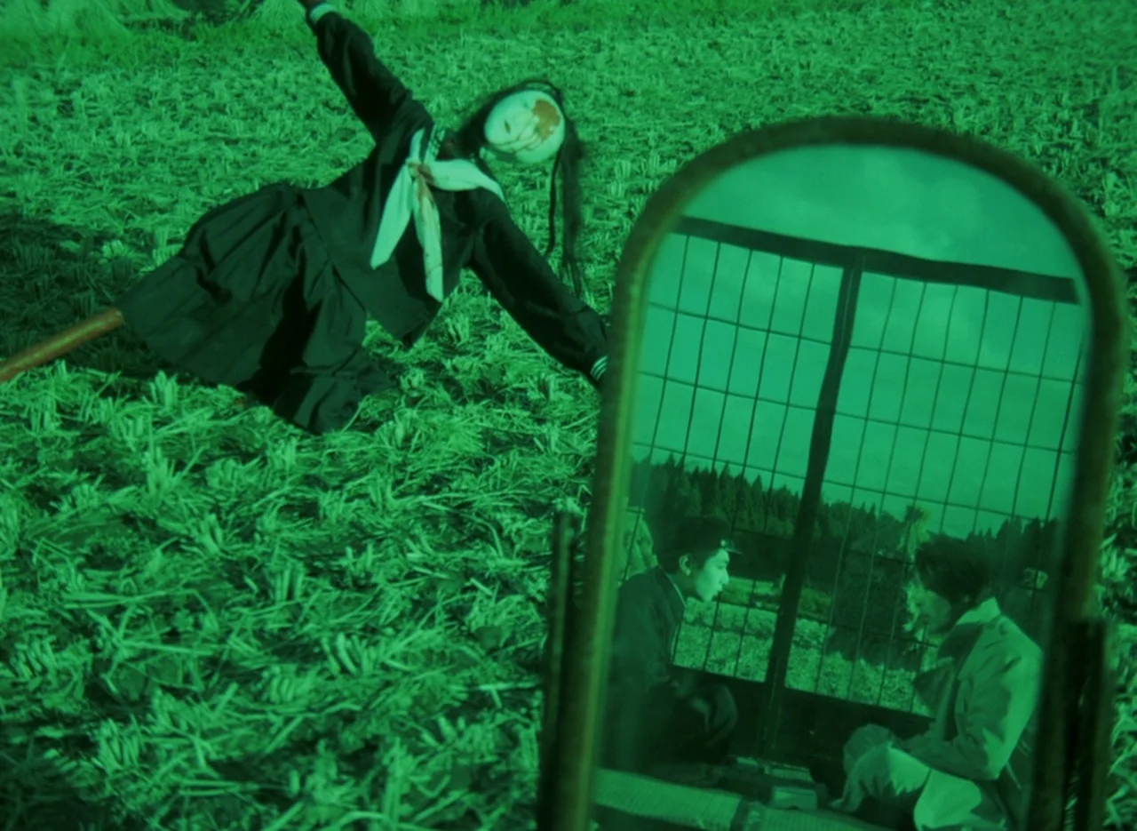 Pastoral To Die In The Country (1974) movie still: wide — A dark rural field covered in harvested crop stalks is bathed in green night-vision light.…