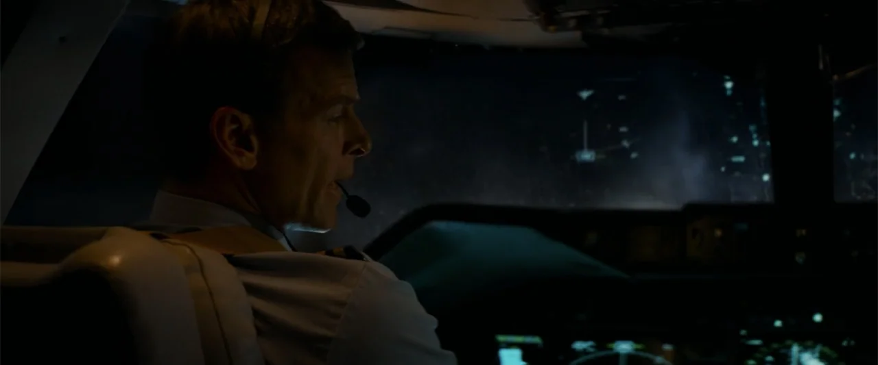 The Amazing Spider-Man 2 (2014) movie still: medium — A dark airplane cockpit at night features glowing green navigation screens and flight…