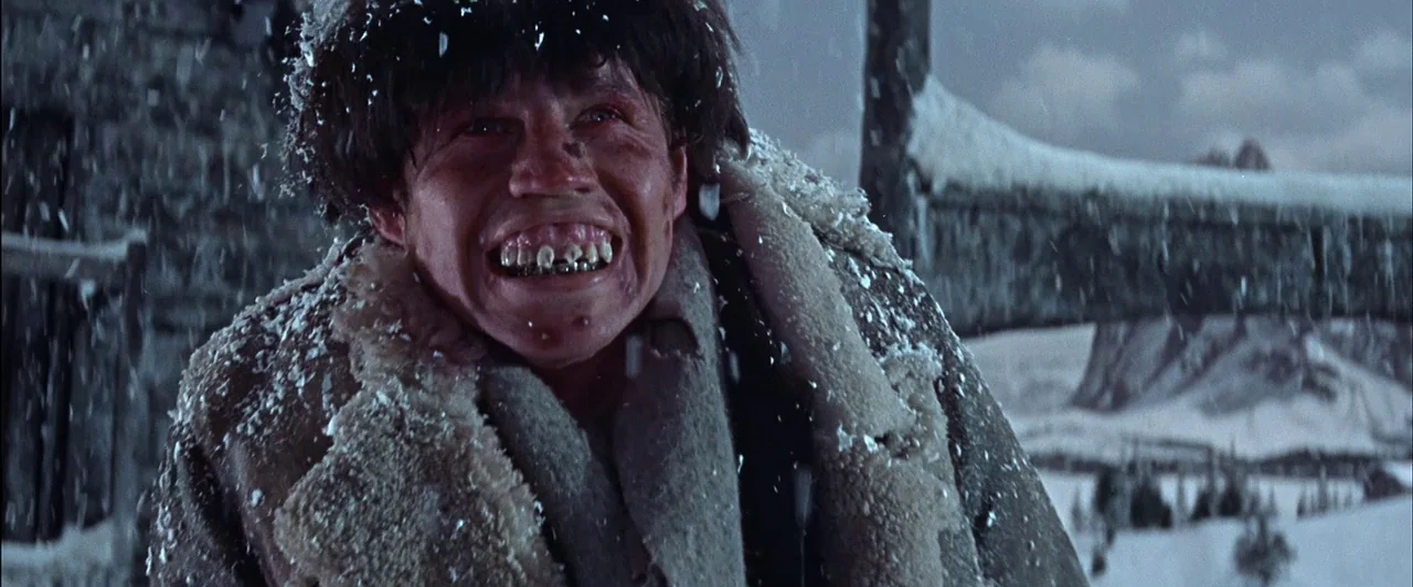 The Fearless Vampire Killers (1967) movie still: medium — A snowy mountain landscape features a person wearing a thick sheepskin-lined leather coat.…