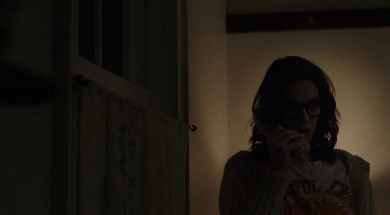 I Am The Pretty Thing That Lives In The House (2016) movie still: medium — An interior wall at night with a window covered by a thin curtain. A…