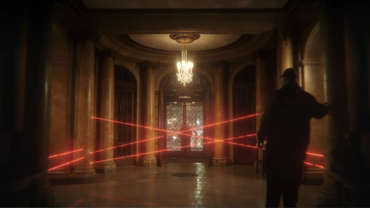 Megalopolis (2024) movie still: wide — A grand neoclassical lobby features marble columns and a central hanging crystal chandelier. A man in dark…