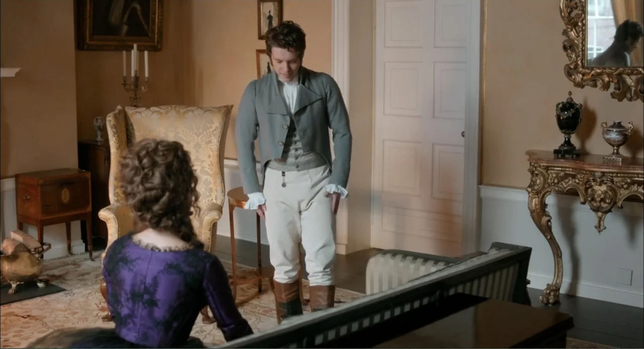 Love & Friendship (2016) movie still: fullbody — A refined 19th-century parlor features ornate gold-framed mirrors and yellow upholstered antique…