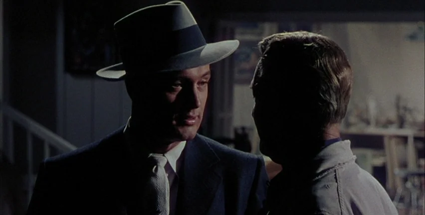 Magnificent Obsession (1954) movie still: medium — An interior space features two men standing in dim lighting during the night. A man wearing a…
