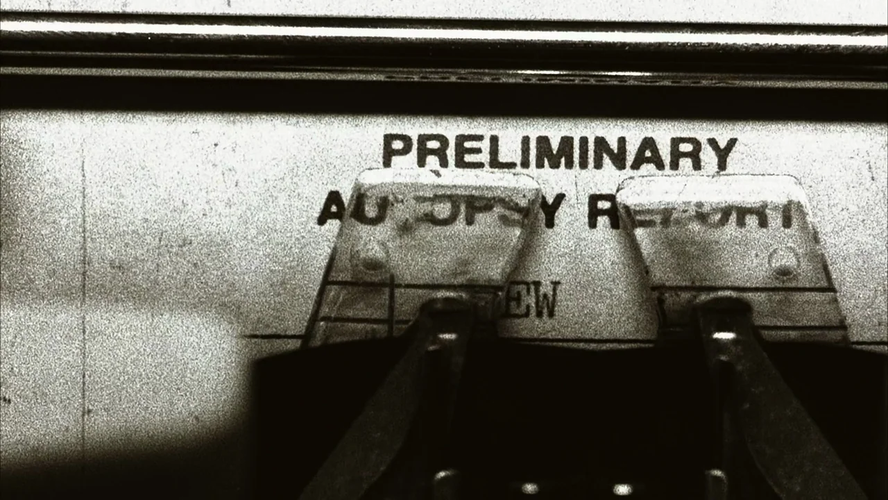 The Texas Chainsaw Massacre (2003) movie still: closeup — A close-up view of a typewriter carriage holding a document labeled preliminary autopsy…