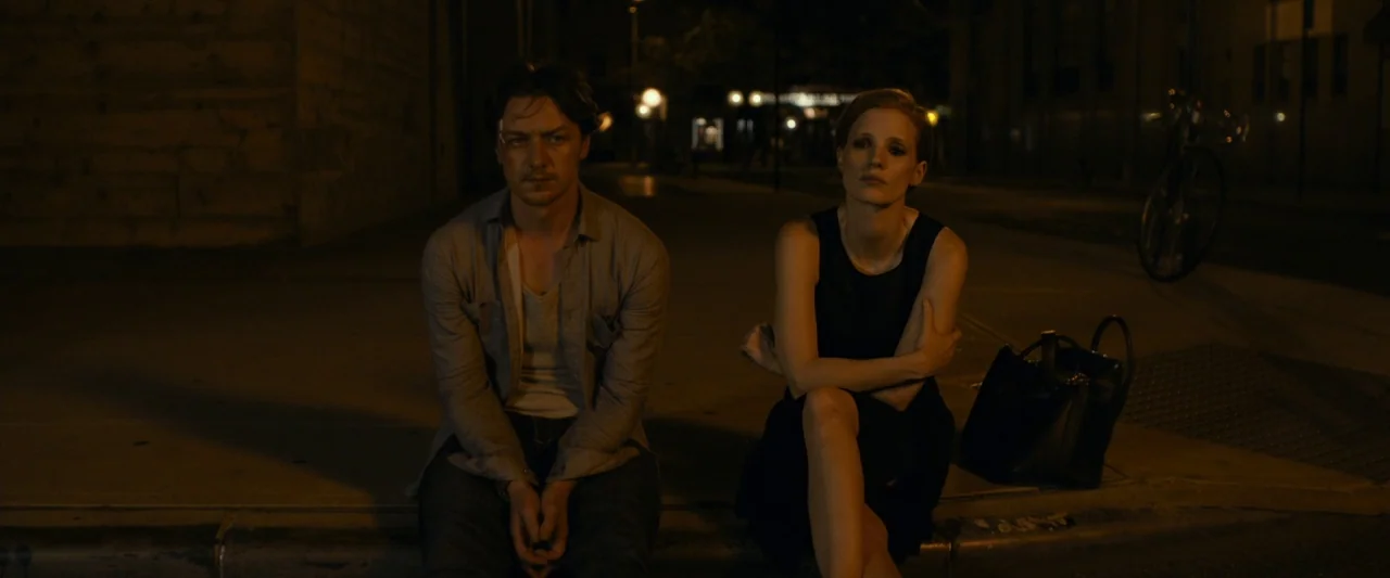 The Disappearance of Eleanor Rigby: Her (2014) movie still: medium — A man and a woman sit on a dark city curb at night. The background features…