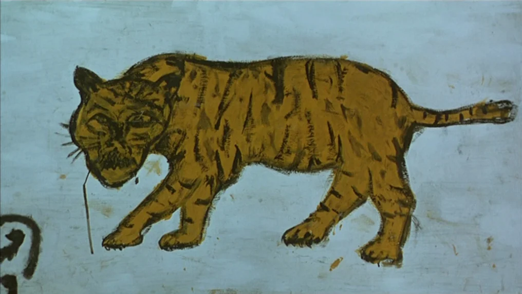 Tropical Malady (2004) movie still: medium — A wall surface features a primitive painted representation of a tiger. The tiger is depicted in brown…