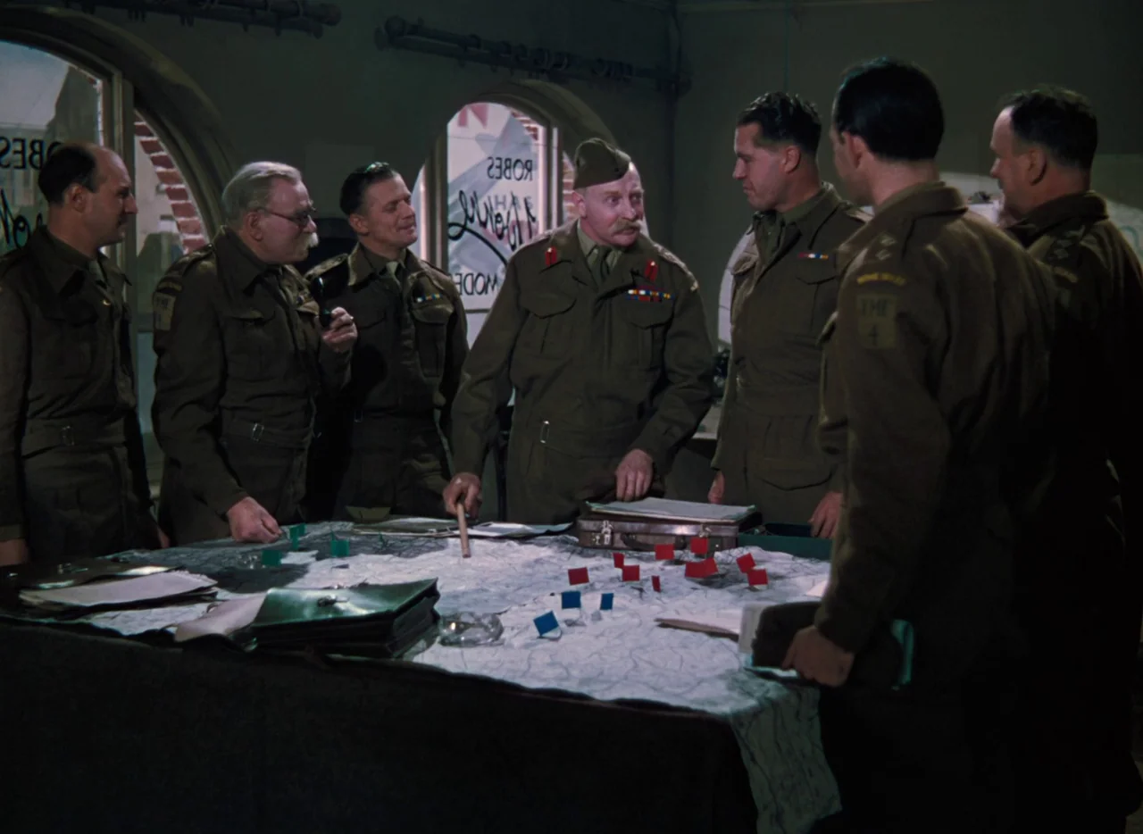 The Life and Death of Colonel Blimp (1943) movie still: wide — An interior military headquarters features arched windows looking onto a street with…