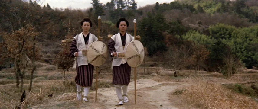 Lone Wolf: Baby Cart at the River Styx (1972) movie still: fullbody — A rural dirt path winds through a dry, hilly landscape with sparse winter…