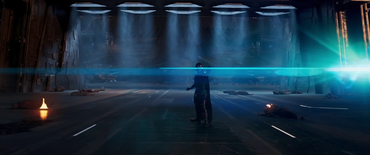 Ant-Man and the Wasp: Quantumania (2023) movie still: wide — A dark metallic hangar bay features rows of floor lights creating vertical hazy beams.…