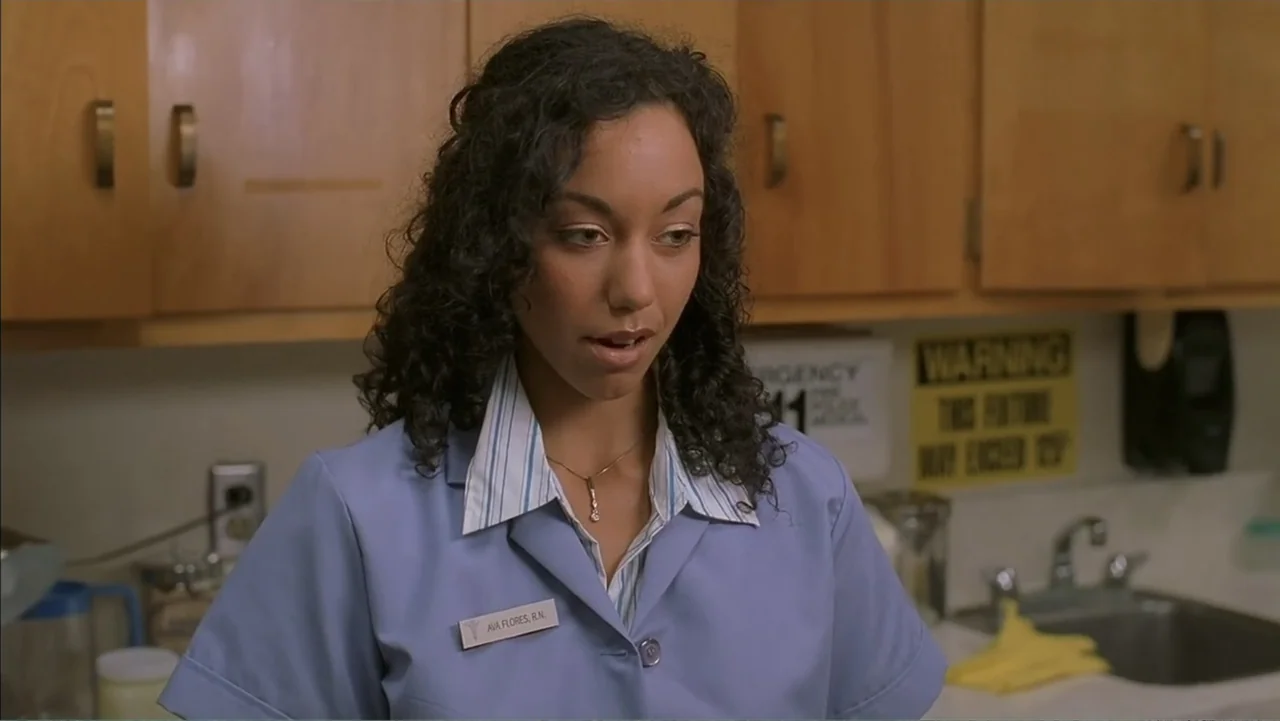 Day of the Dead 2: Contagium (2005) movie still: medium — A medical station features wooden cabinets and a stainless steel sink in the background. A…