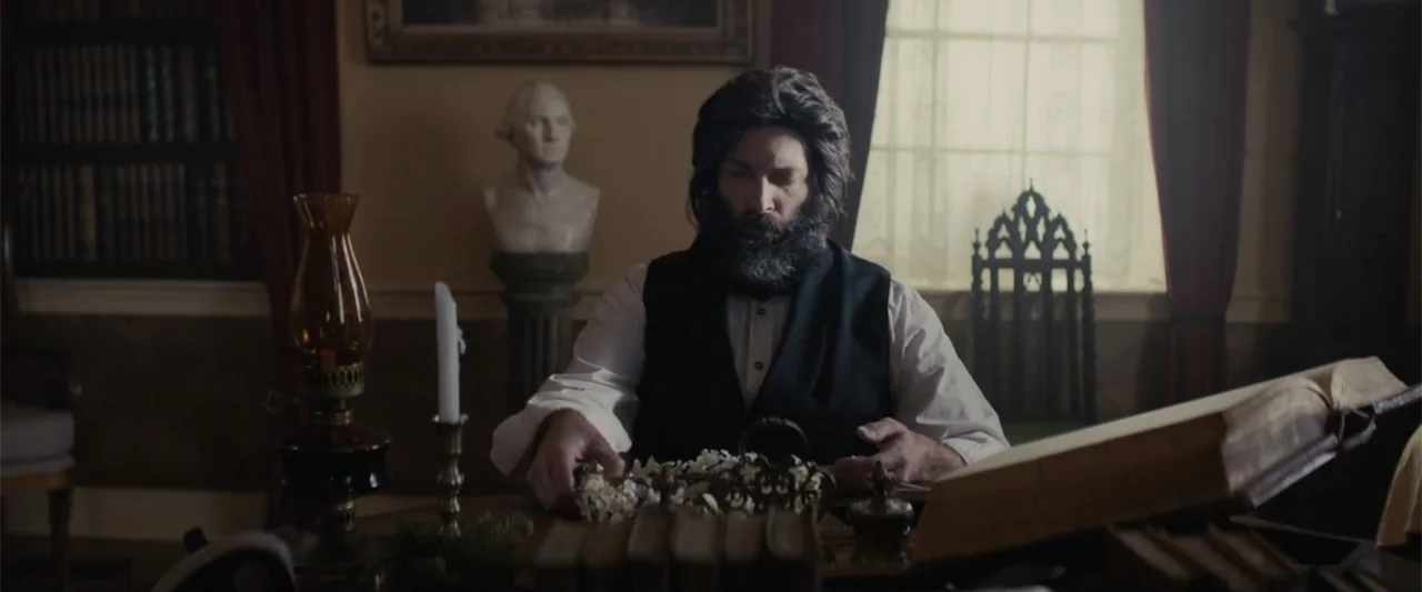 I Heard the Bells (2022) movie still: medium — A nineteenth-century study features a wooden desk, bookshelves, and a bust of George Washington. A…