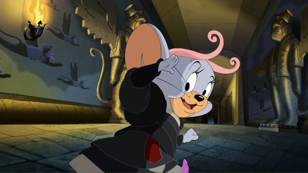 Tom and Jerry & The Wizard of Oz (2011) movie still: medium — A stone corridor lined with large statues and wall carvings in a fantasy structure. A…
