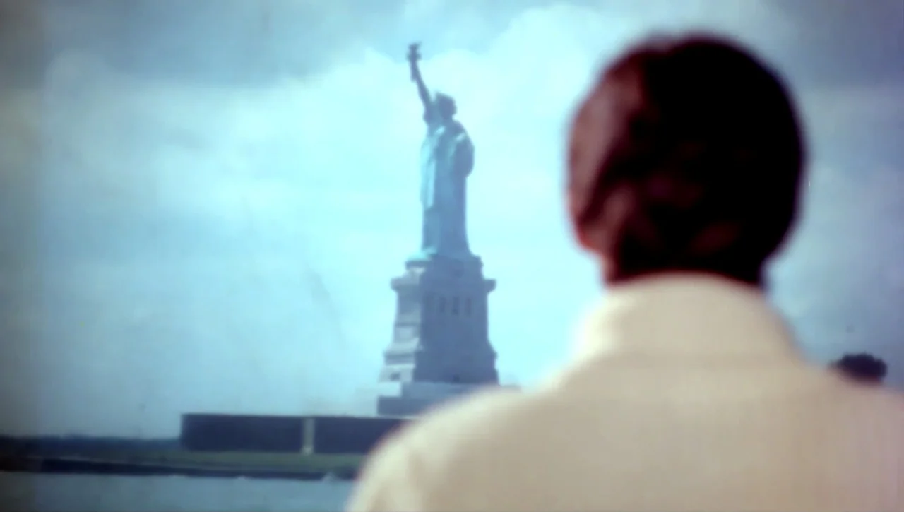 Alexandria…Why? (1979) movie still: medium — A view across a body of water toward a prominent historical monument. A man stands in the foreground…