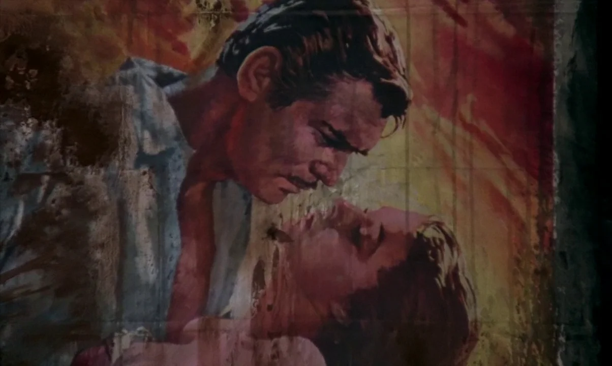 Cinema Paradiso (1988) movie still: medium — A faded, peeling mural on an outdoor wall depicts a romantic embrace. A man and woman in a painted…