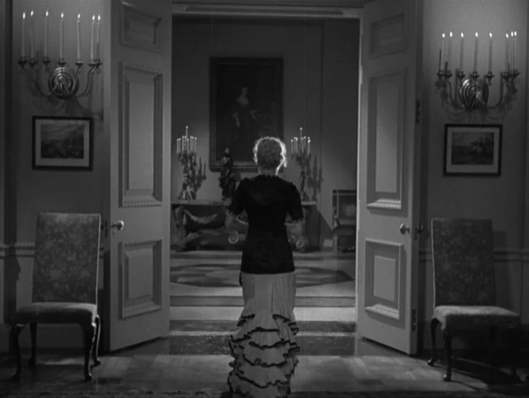 Dr. Jekyll and Mr. Hyde (1931) movie still: fullbody — A symmetric interior doorway opens into a dimly lit hall containing paintings and…