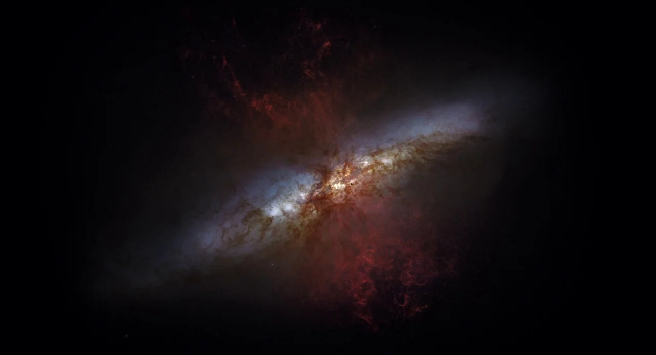 Voyage of Time (2016) movie still: establishing — A massive spiral galaxy floats in the dark void of deep space. Glowing gas clouds and dense star…
