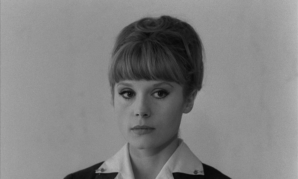 La Peau Douce (The Soft Skin) (1964) movie still: closeup — A woman is positioned in front of a plain, light-colored background. She faces forward…
