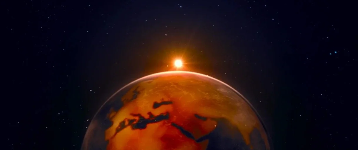 Bergman Island (2021) movie still: establishing — The curved limb of a planet is silhouetted against the dark expanse of space. A bright sun flares…