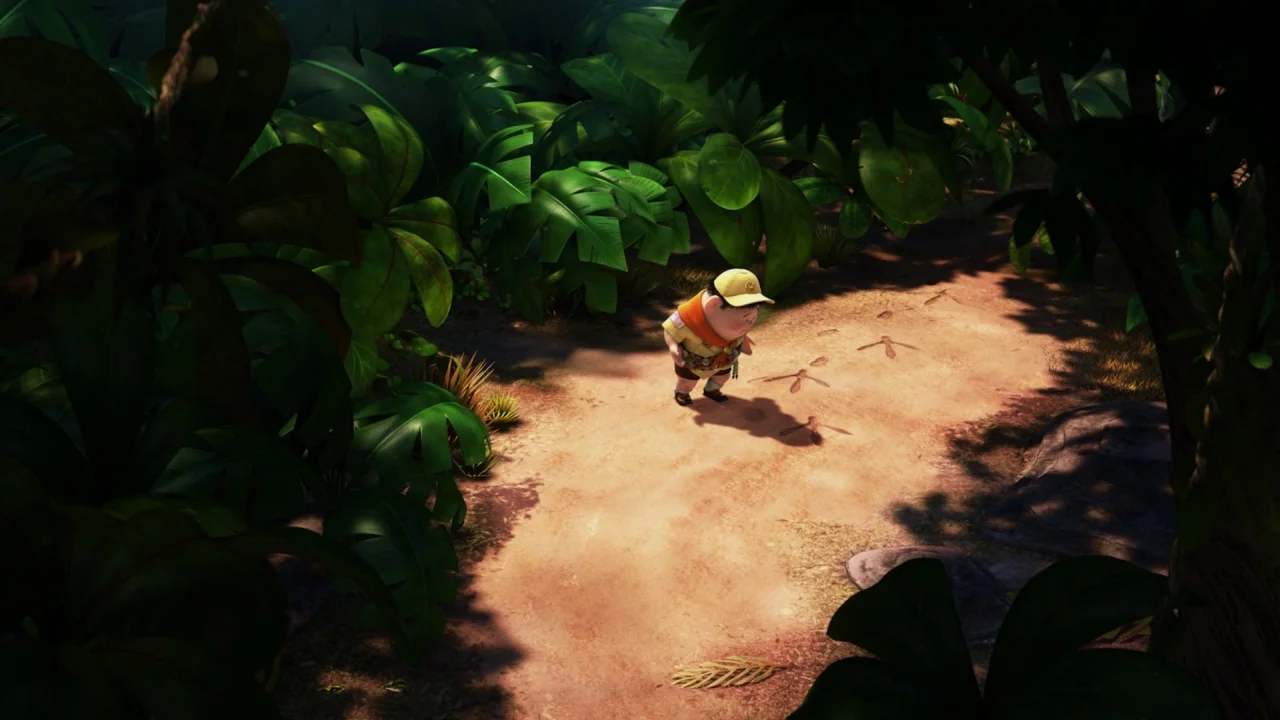 Up (2009) movie still: wide — A dirt path cuts through a dense tropical jungle filled with large lush leaves. A young boy in a scout uniform…