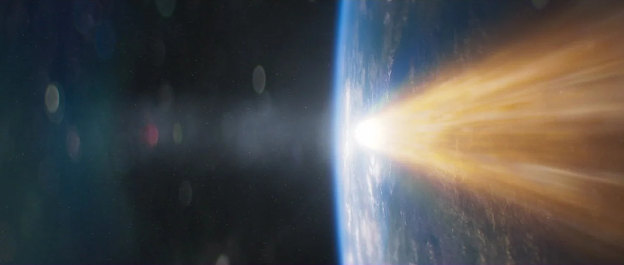 Annihilation (2018) movie still: establishing — The curvature of a blue and white planet is visible against deep black space. A bright streak of…